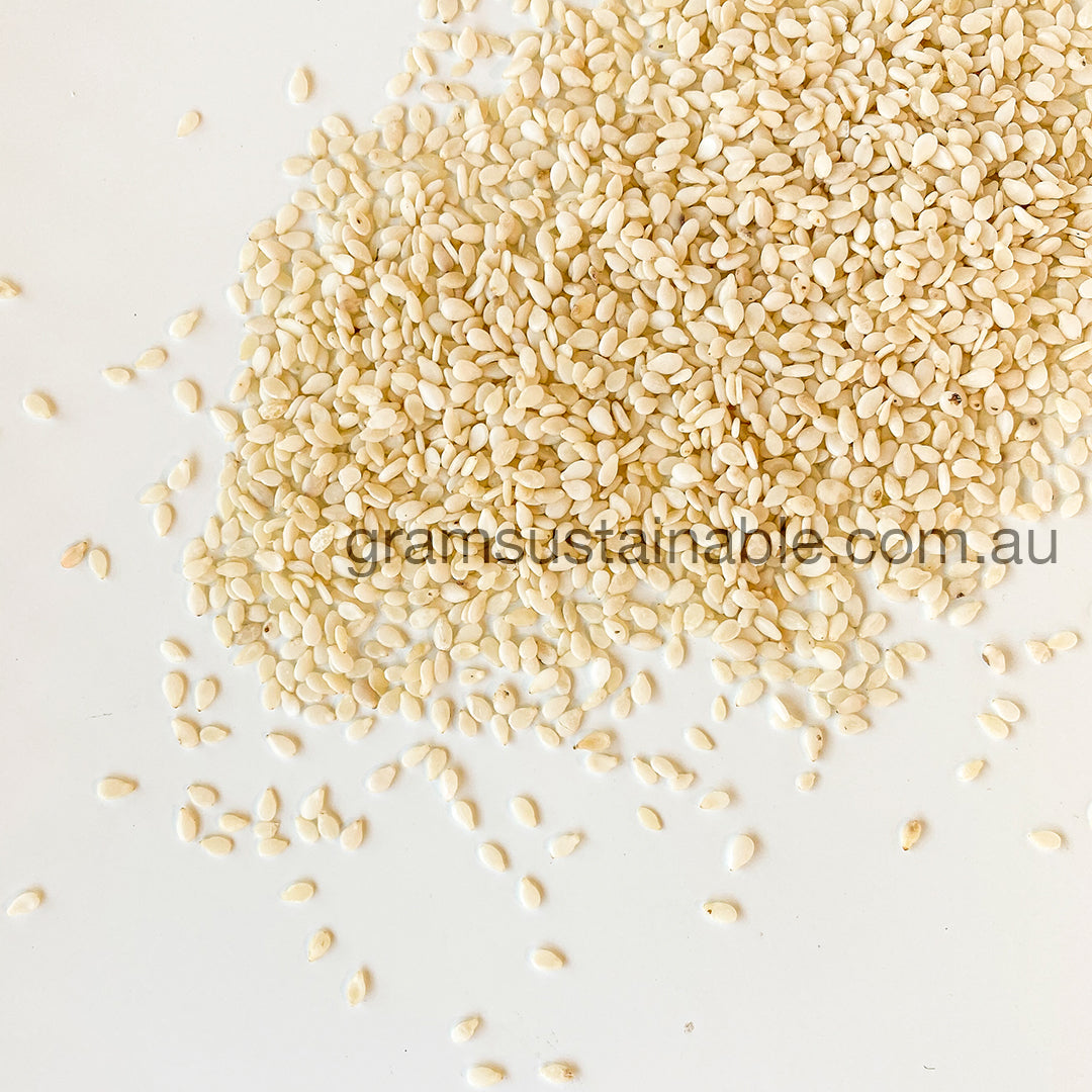 A scattered pile of white sesame seeds