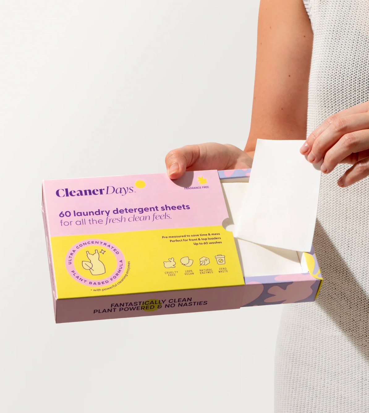 Person holding a box of CleanerDays laundry detergent sheets with a white background