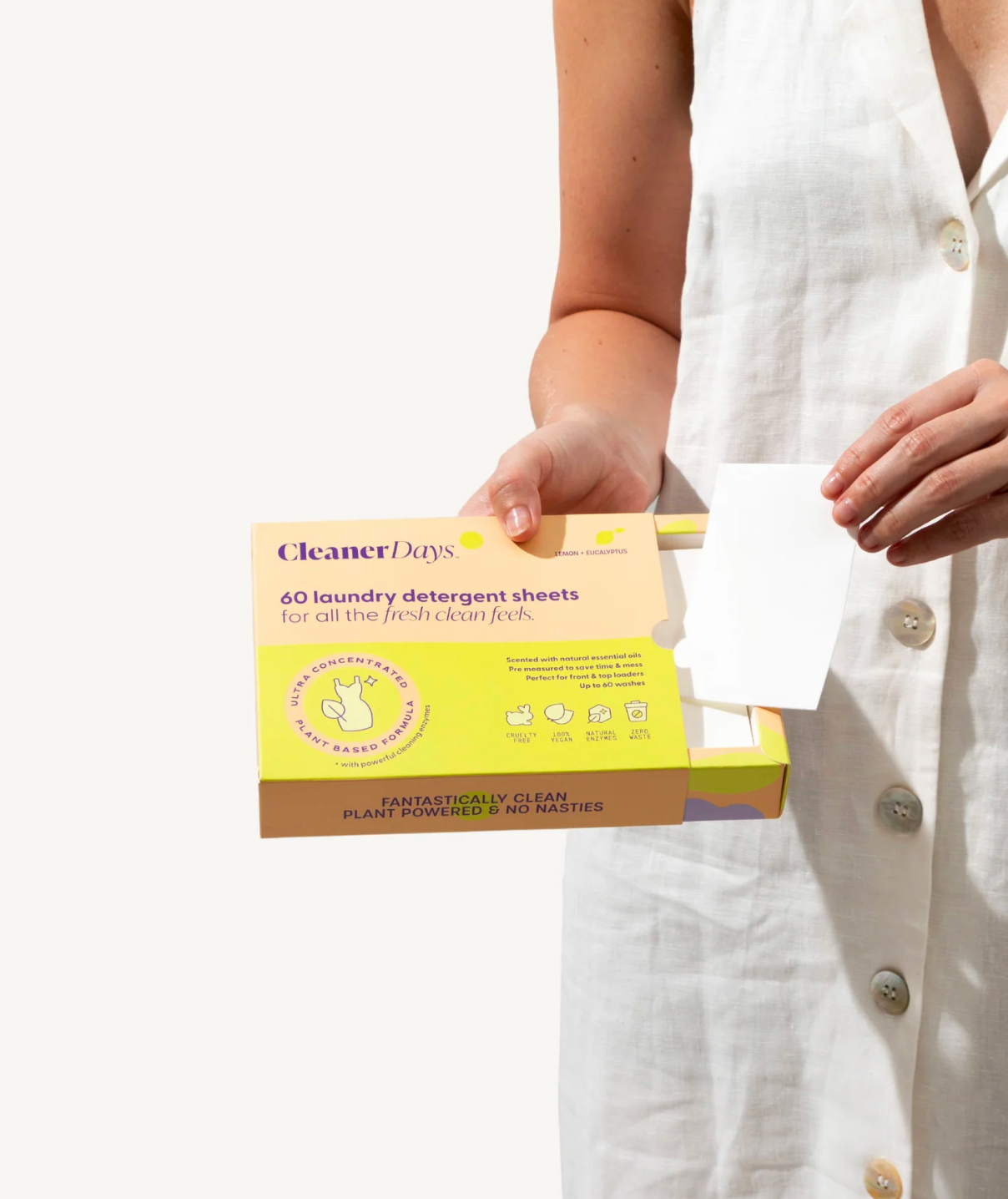 Person holding a box of Cleaner Days laundry detergent sheets against a white background