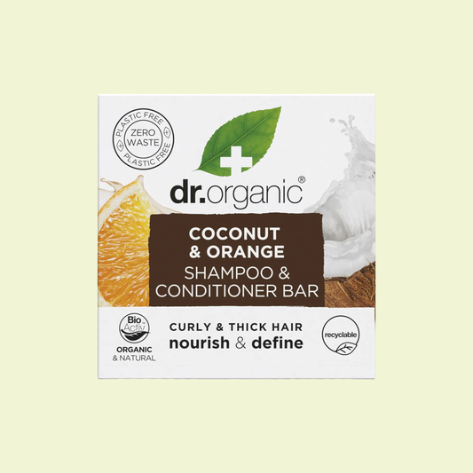 Dr. Organic coconut and orange shampoo and conditioner bar packaging on a light yellow background