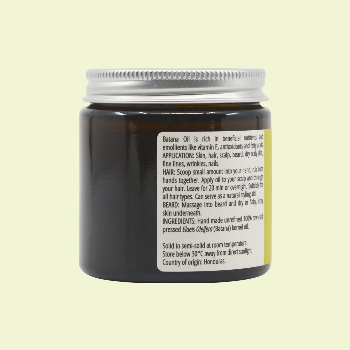 Jar of Batana Oil with label on a light yellow background