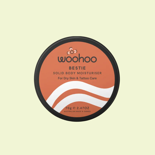 Container of woohoo Bestie Solid Body Moisturizer on a light beige background